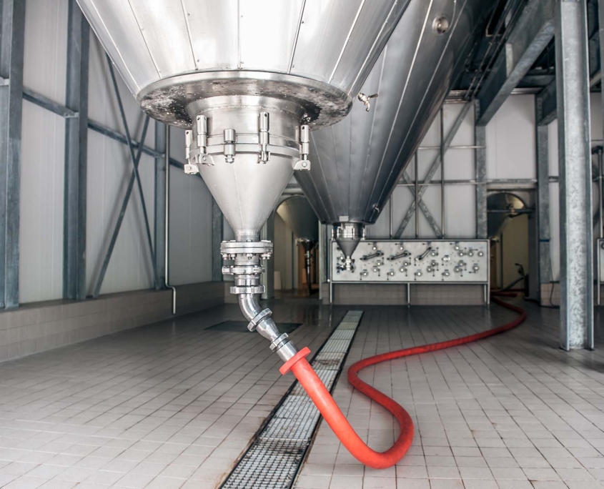 Hose connected to a storage tank at a beer brewery