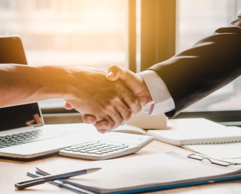 Image of two business people shaking hands on a loan.