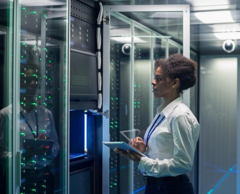 Technician working on computer in data center