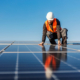 A handyman installing solar panels on the rooftop